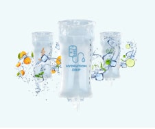 Three iv hydration bags with fruit and vitamin illustrations, depicting health and wellness themes, against a light blue background.