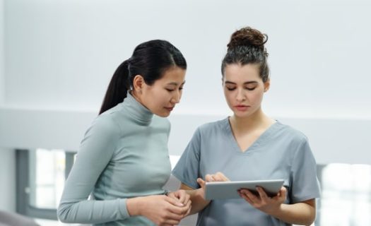 2 women looking on the tablet