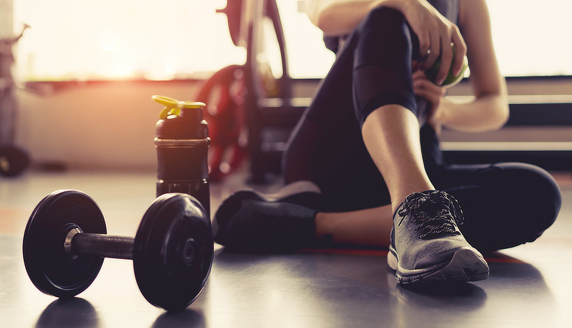 woman resting after exercising at the gym