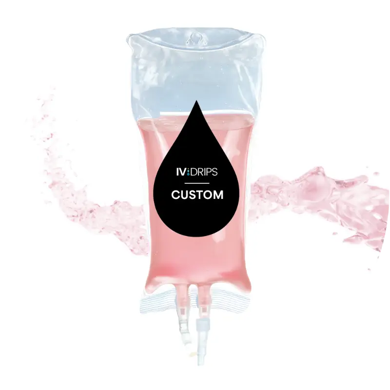 Clear IV fluid bag filled with pink liquid labeled "IV:DRIPS CUSTOM," with a splash of pink liquid in the background.