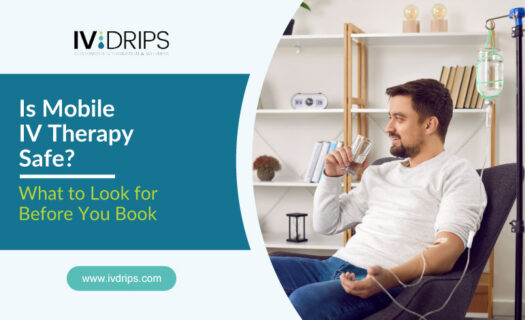 A man sits comfortably on a sofa with an IV drip attached to his arm, smiling and holding a glass of water. Text reads, Is Mobile IV Therapy Safe? What to Look for Before You Book. Website: ivdrips.com.